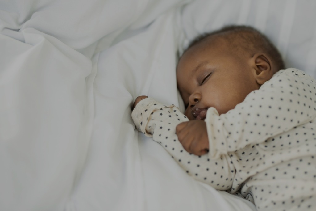 Baby sleeping on sheets