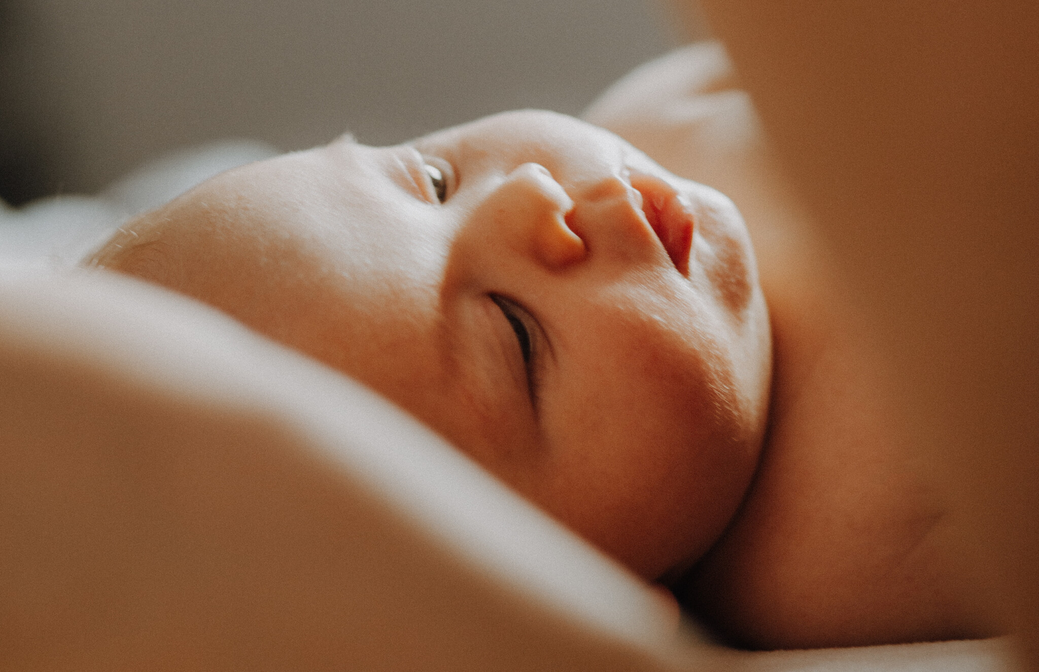 Up close of a baby looking at mother