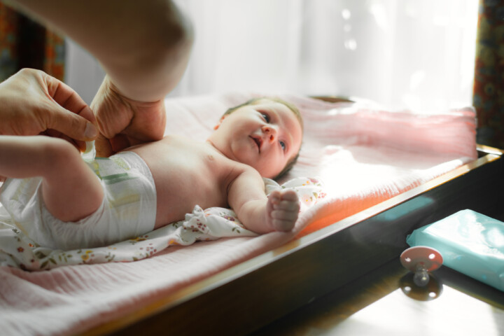 Father changing his baby's diaper
